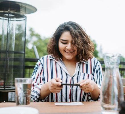 woman taking picture of check